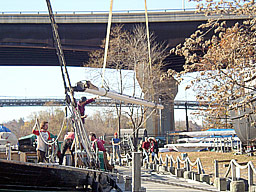 Boom being hoisted off the sloop