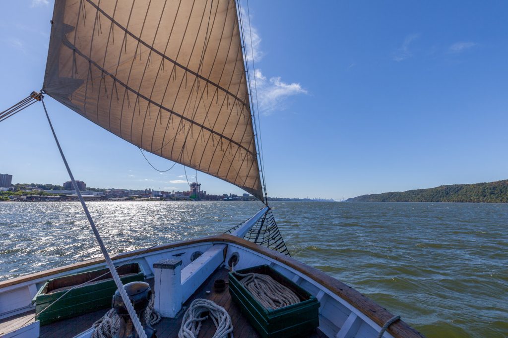 A photo of the Hudson River Sloop Clearwater's foredeck while sailing on a clear, sunny day on the Hudson River near Yonkers. Photo by Alon Koppel