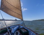 A photo of the Hudson River Sloop Clearwater's foredeck while sailing on a clear, sunny day on the Hudson River near Yonkers. Photo by Alon Koppel