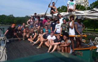 An image of the participants in the 2017 LGBTQ+Allies Youth at the Helm program gathering on the stern of the Clearwater and on top of the boom.