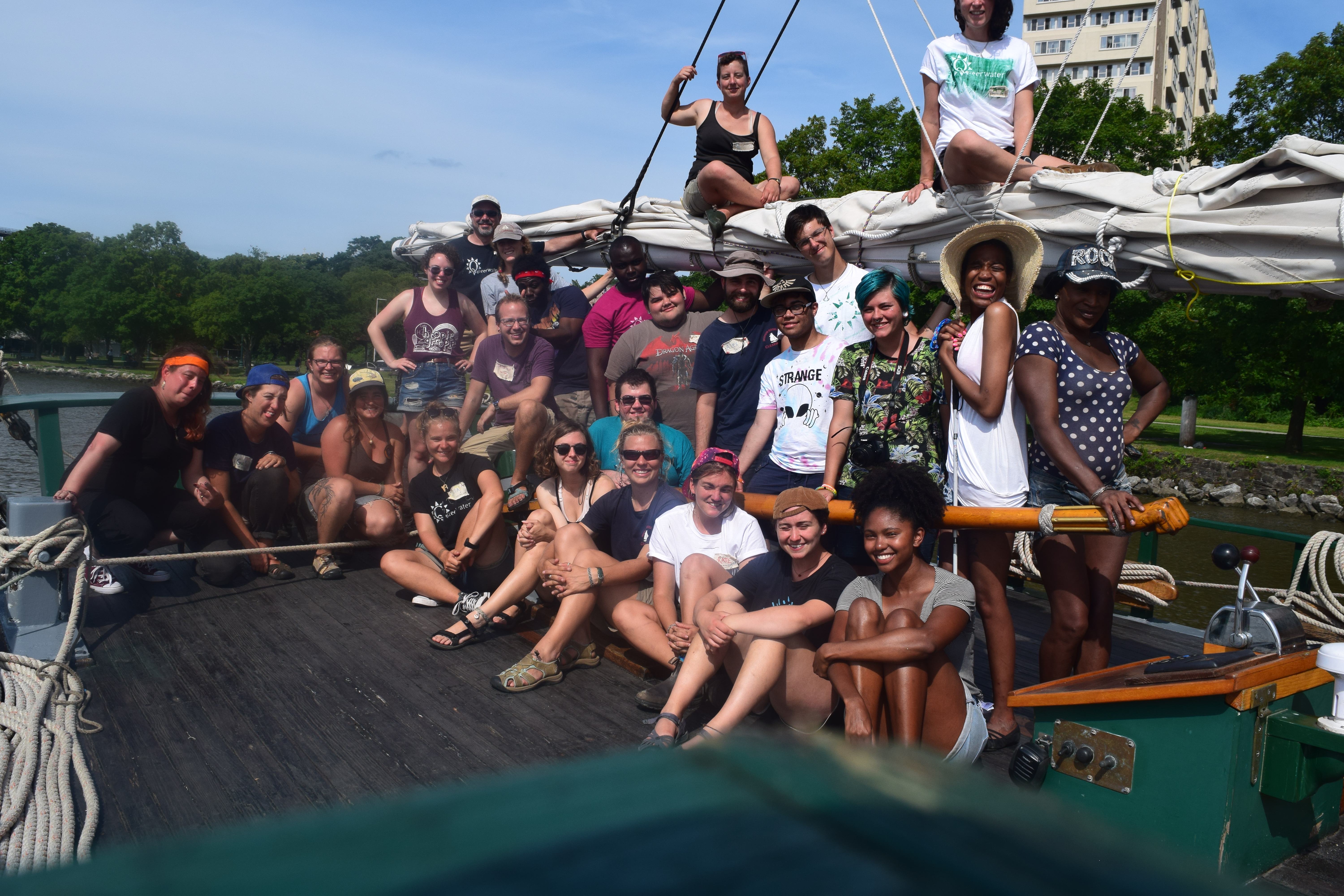 An image of the participants in the 2017 LGBTQ+Allies Youth at the Helm program gathering on the stern of the Clearwater and on top of the boom.