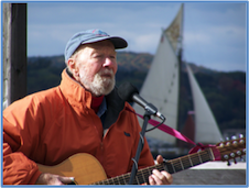 Pete Seeger with Sloop in background